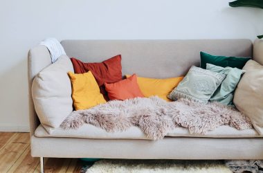 Light coloured sofa with cushions on it